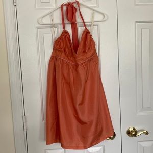 Orange and white polka dot mini halter dress.